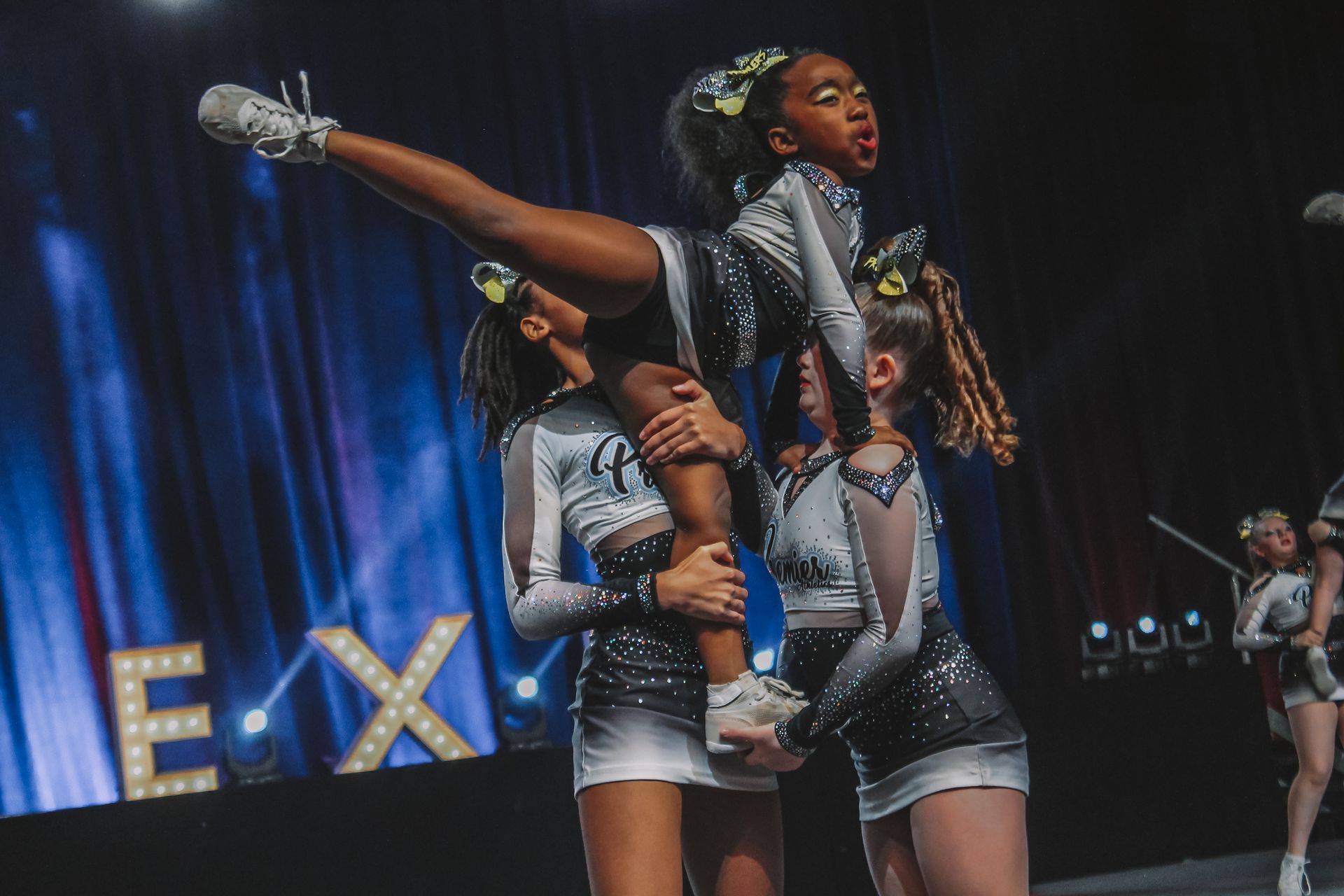 A group of cheerleaders are performing on a stage.