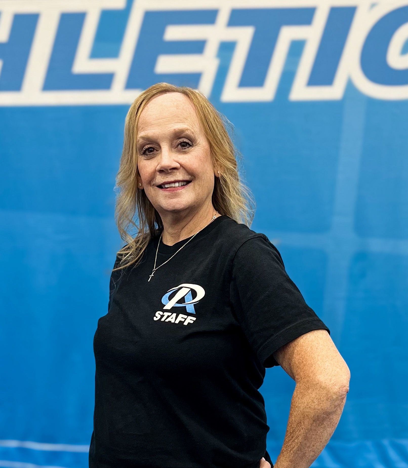 A woman wearing a black shirt with the word staff on it