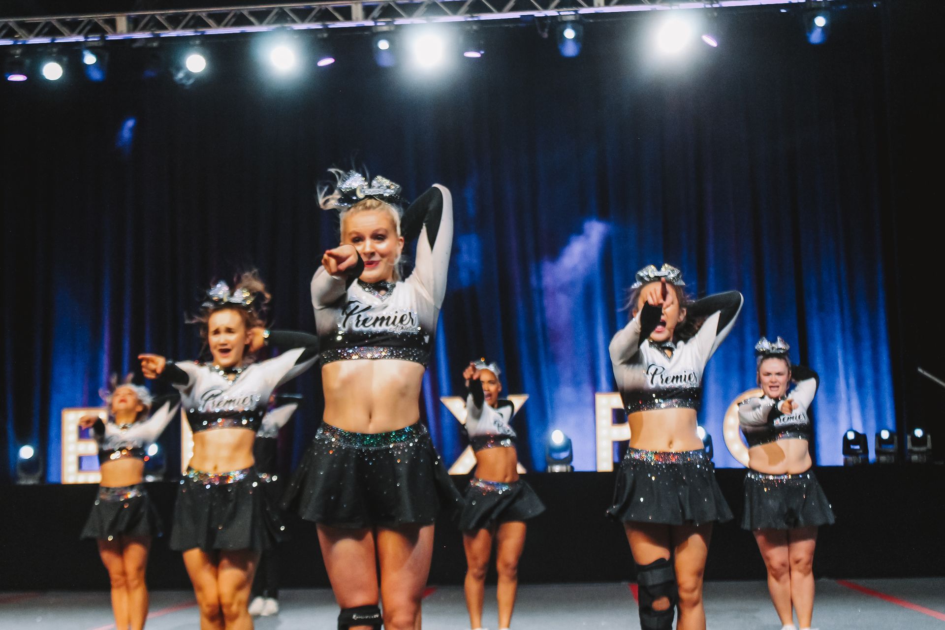 A group of cheerleaders are performing on a stage.