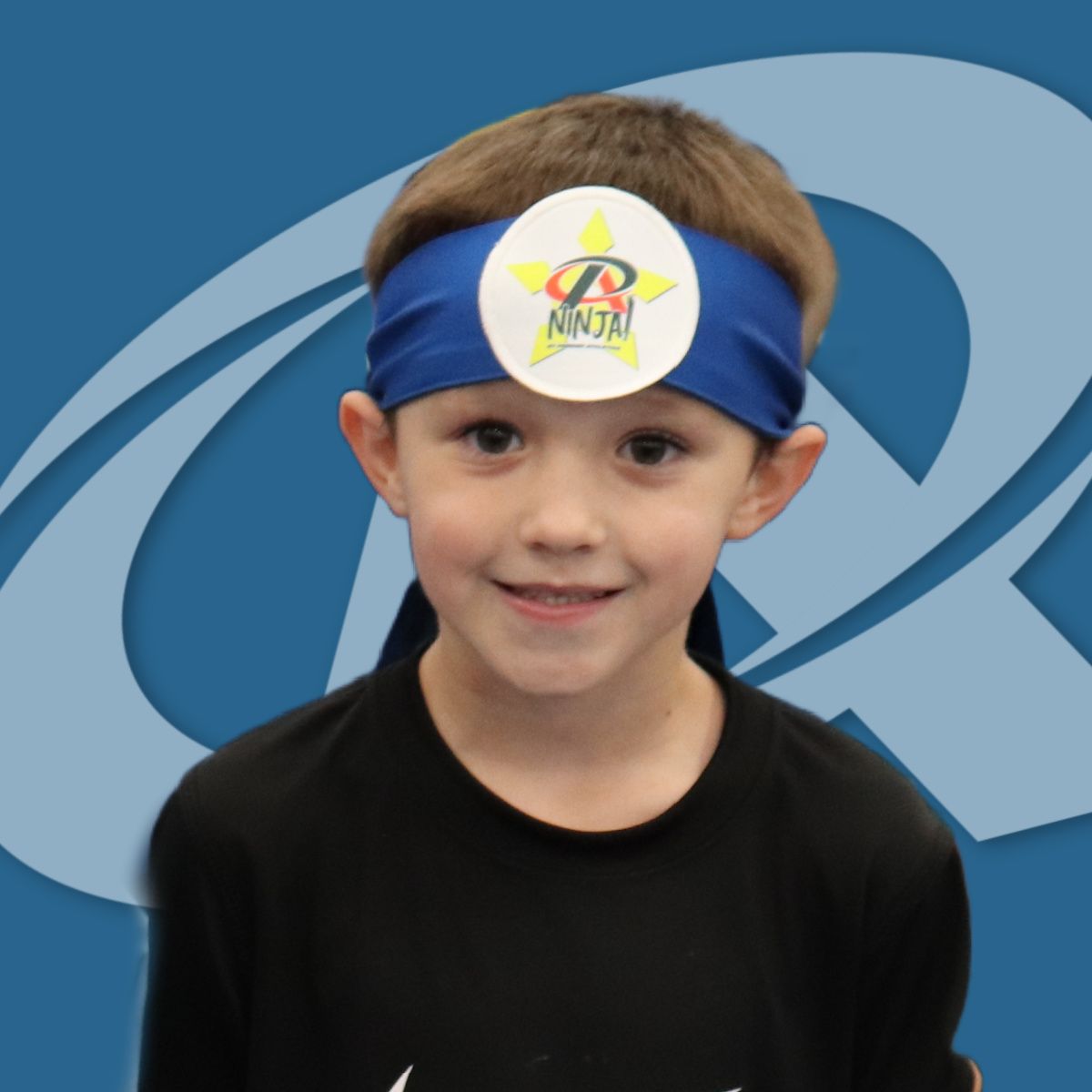 A young boy wearing a headband that says ninja on it