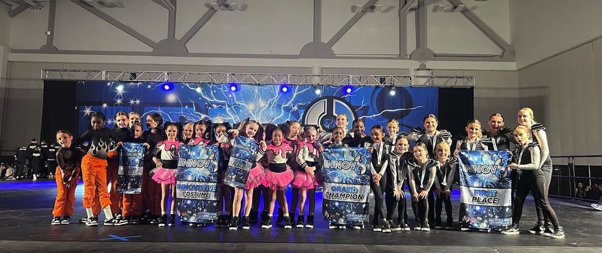 A group of people are posing for a picture on a stage.