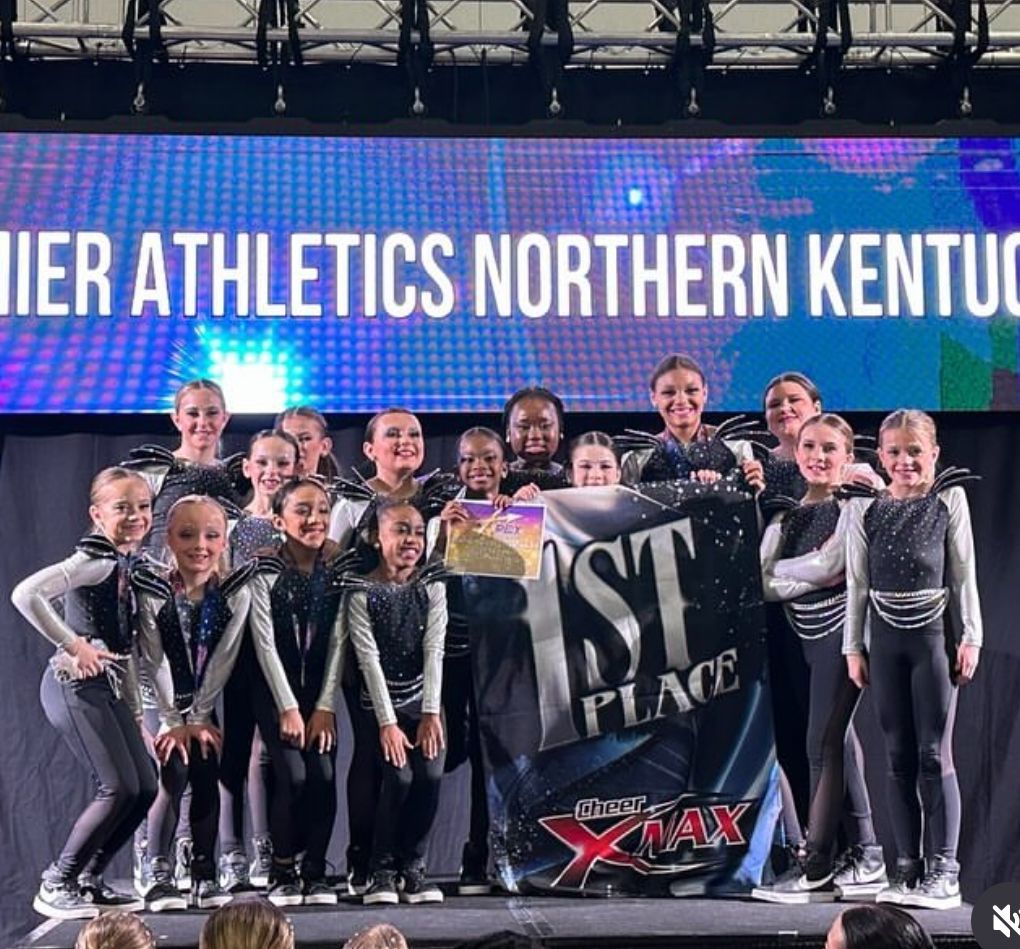A group of children are posing for a picture in front of a sign that says northern kentucky