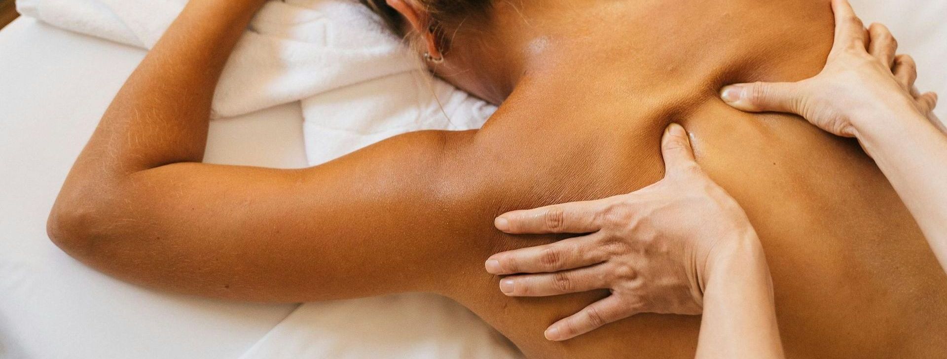 A woman is getting a massage on her back at a spa.