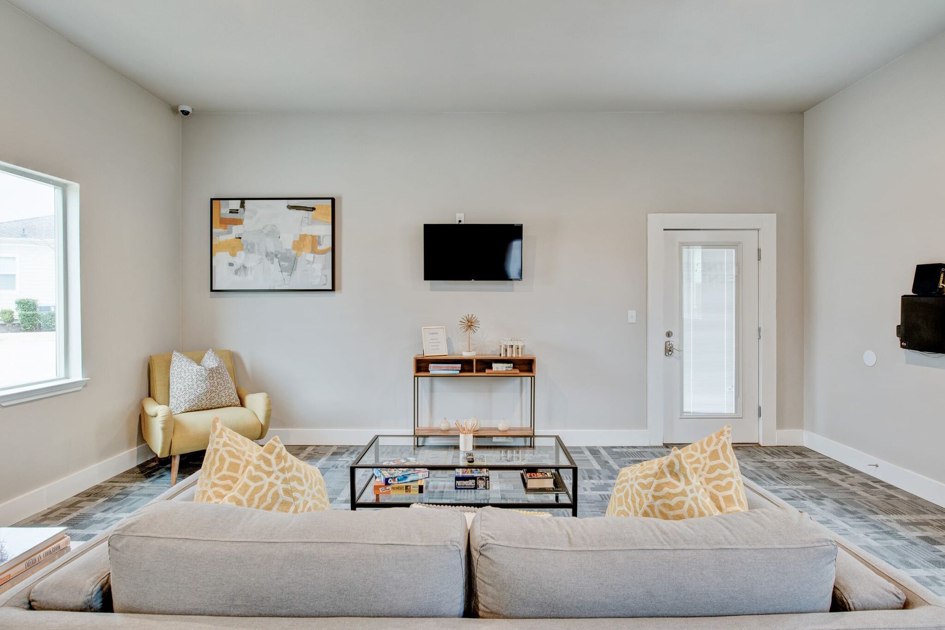 A living room with a couch, chair, coffee table, and television.
