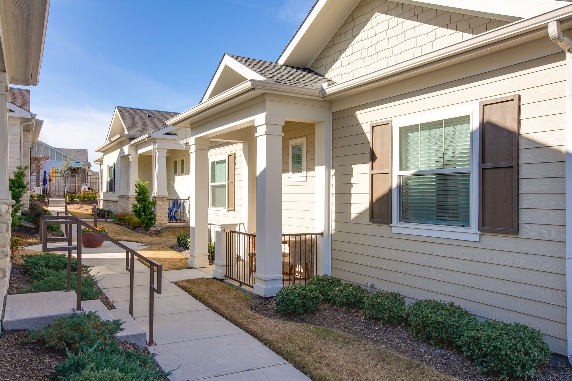A row of houses with a walkway leading to them.