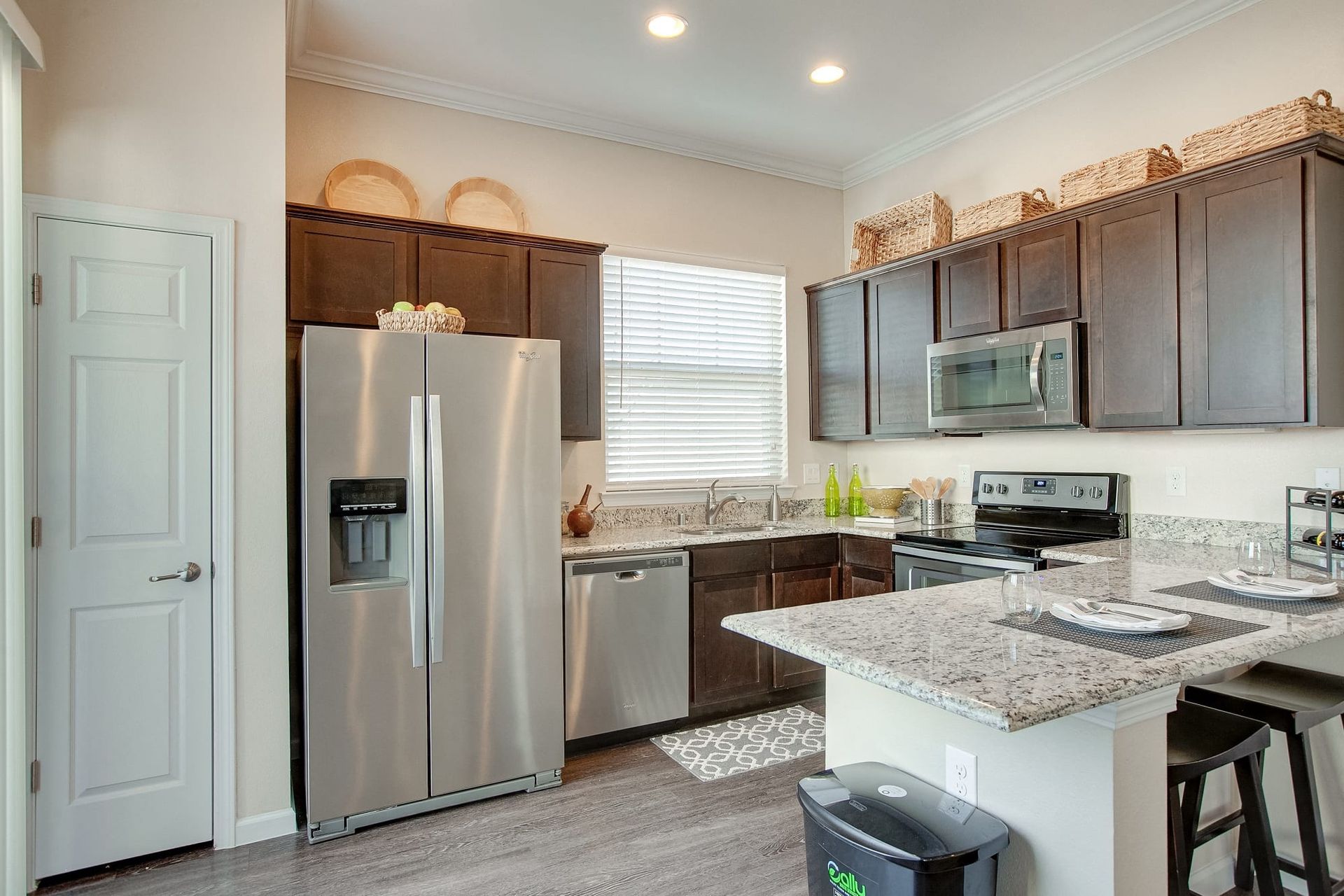 A kitchen with stainless steel appliances and granite counter tops.