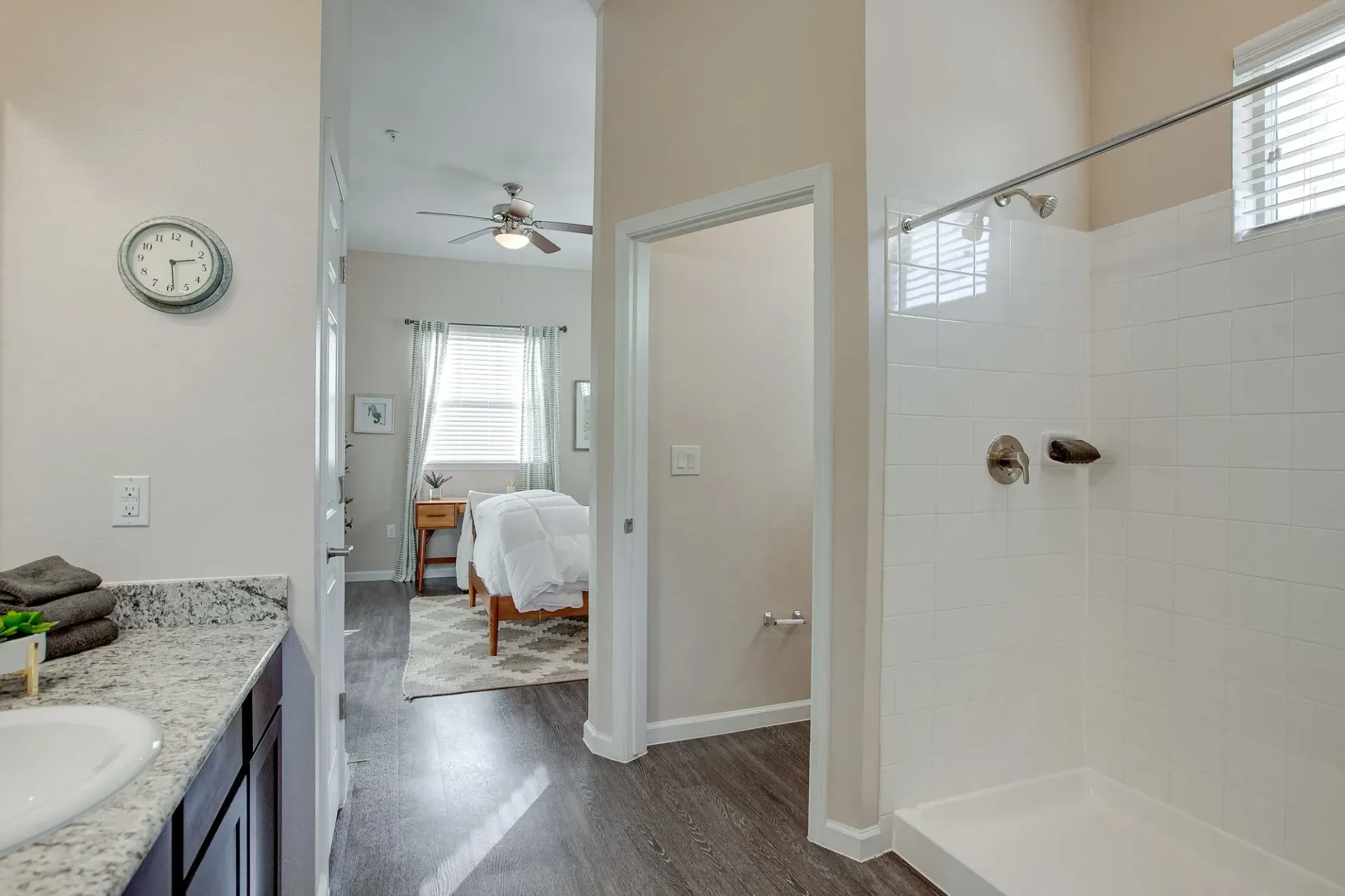 A bathroom with a walk in shower and a sink.