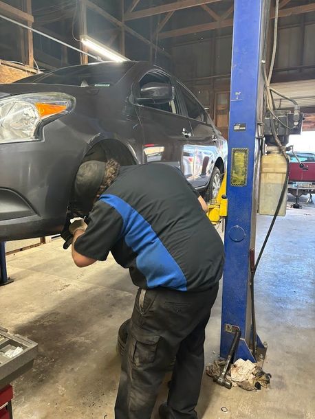 Mechanic working on tire | Hansen Auto Repair