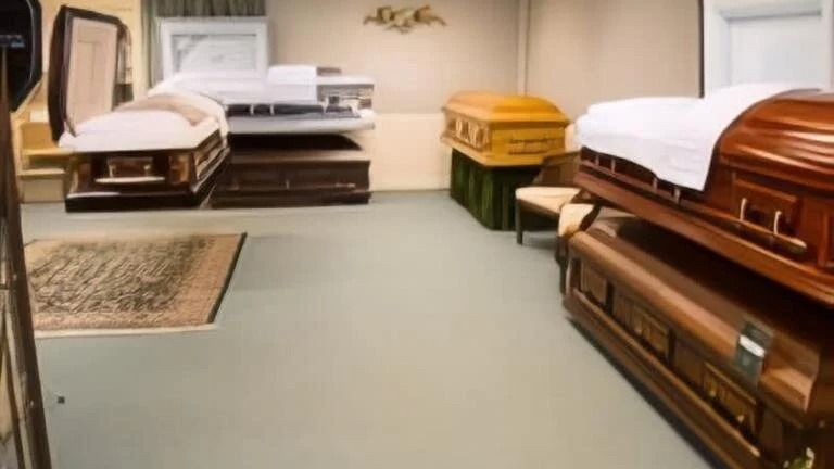 A room with multiple caskets displayed in a funeral home setting; various colors and styles visible.