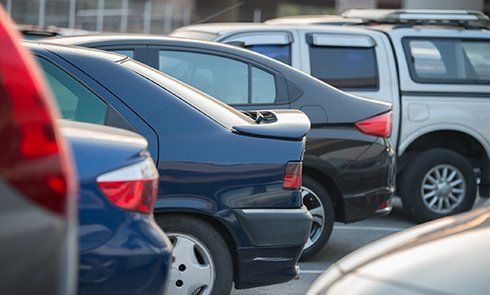 Cars in a row on a parking lot - Towing in  St. Salinas, CA