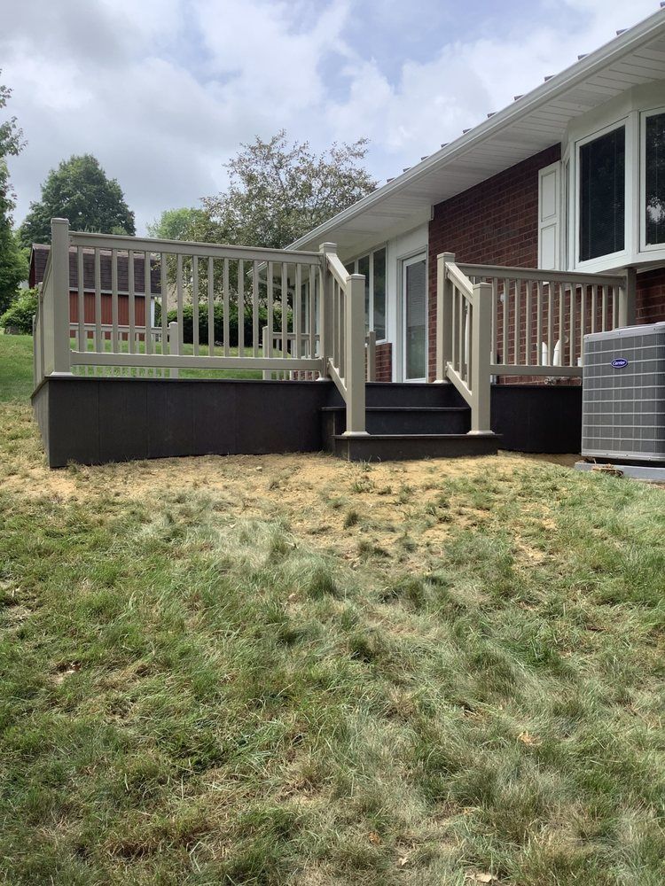 A house with a deck and stairs in front of it.