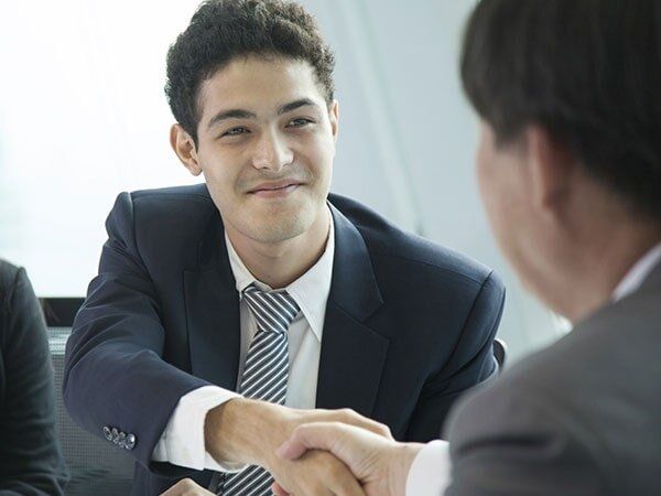 An agreement is being made between a job staffing professional and a client near Purchase, NY