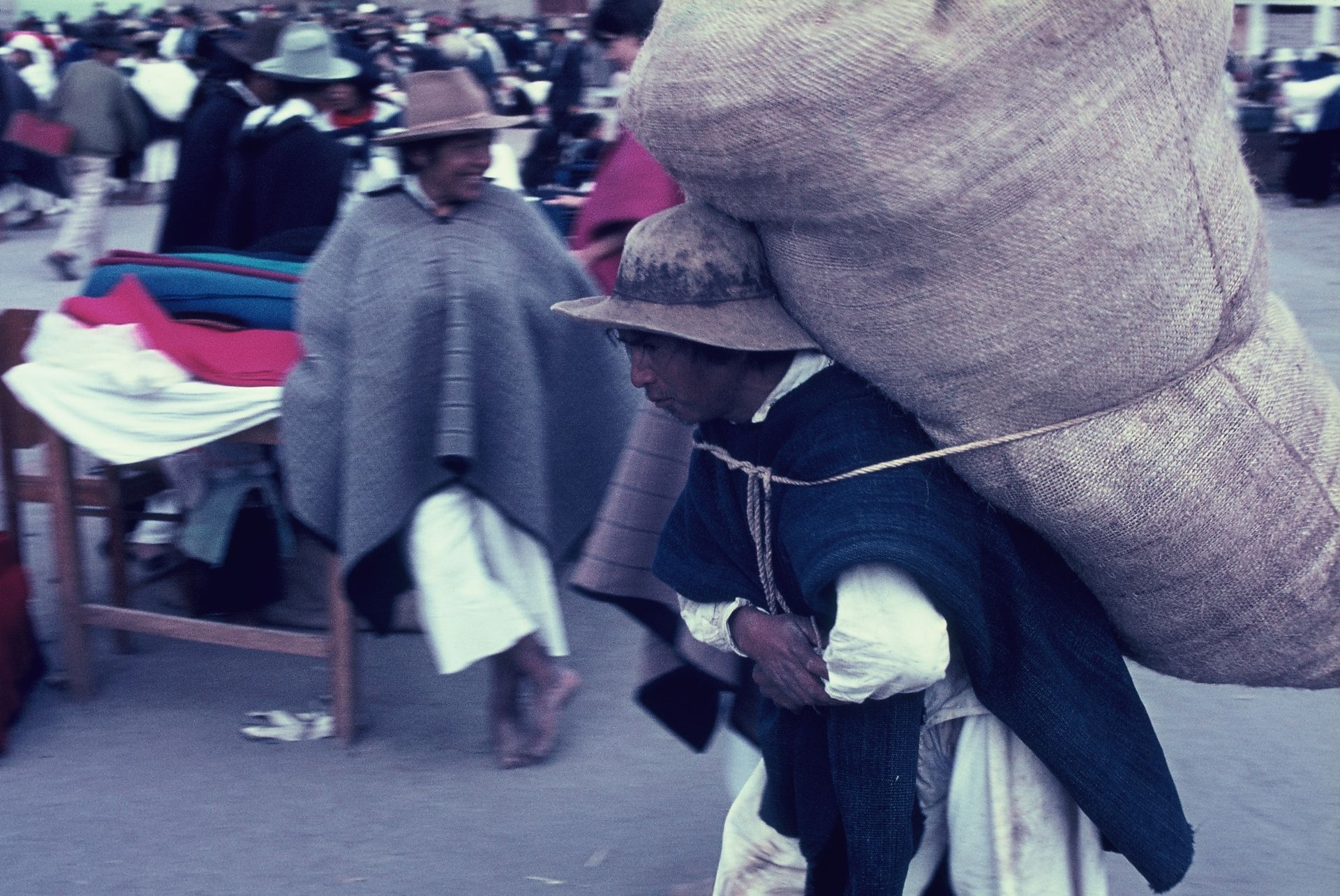 A man is carrying a large bag on his back