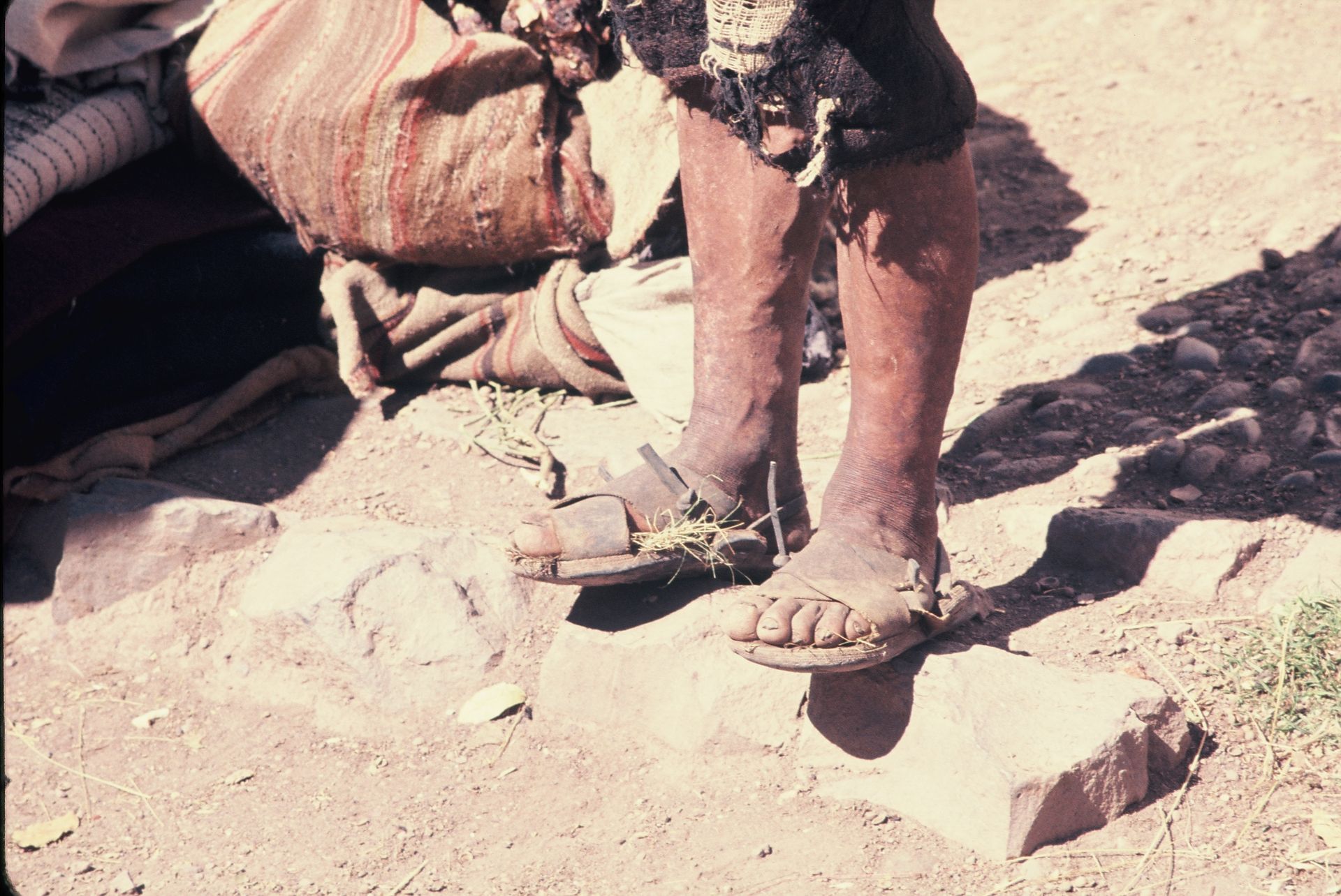 A person standing on a rock wearing sandals