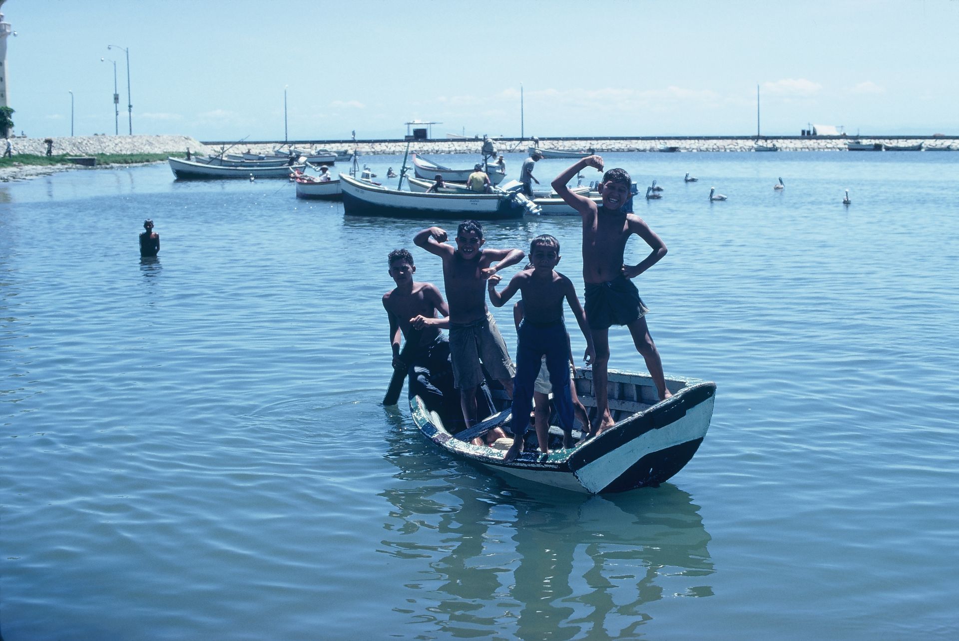 A group of people standing on a boat in the water