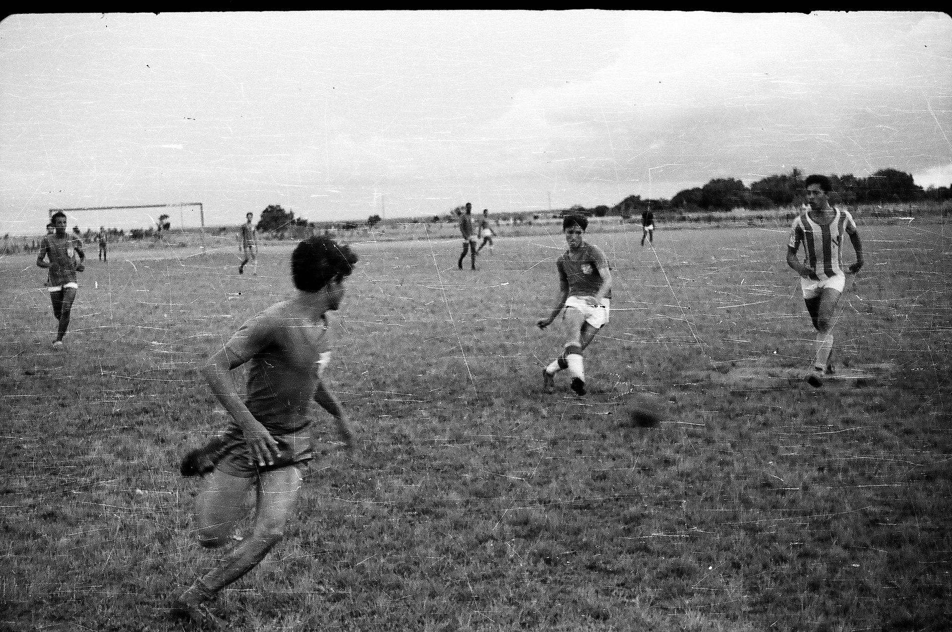 A group of people are playing soccer on a field.
