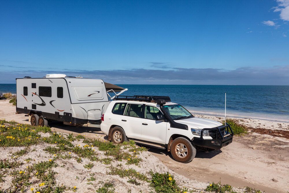 An RV is Parked on the Beach at Sunset — Centre Trailer Hire and Parts In Ciccone, NT