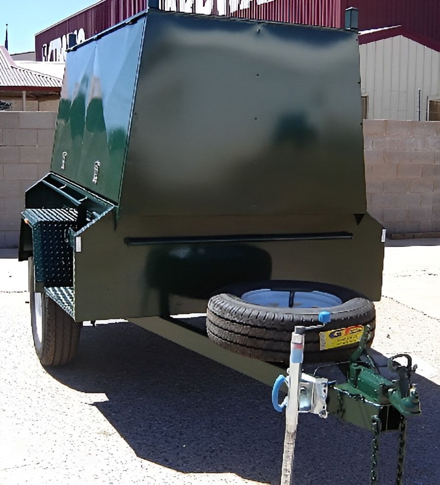 A Green Trailer Is Parked In Front Of A Building — Centre Trailer Hire and Parts In Ciccone, NT