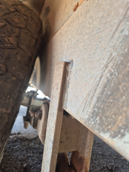 Close-up of a trailer's metal frame, with a tire and axle visible. — Centre Trailer Sales In Alice Springs, NT