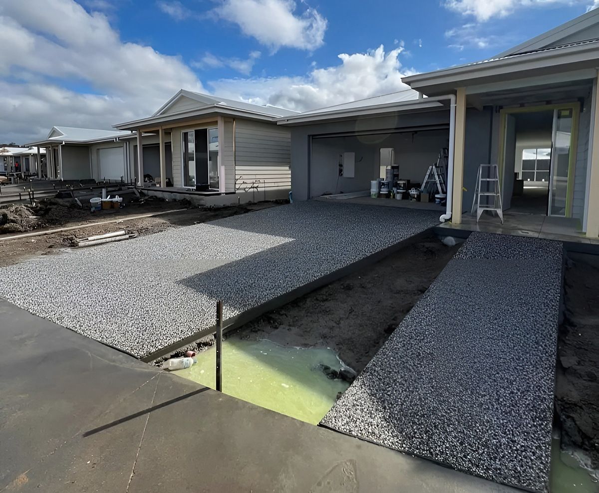 Gravel Driveway with House Construction — Coastal Kerb and Concrete In Buff Point, NSW