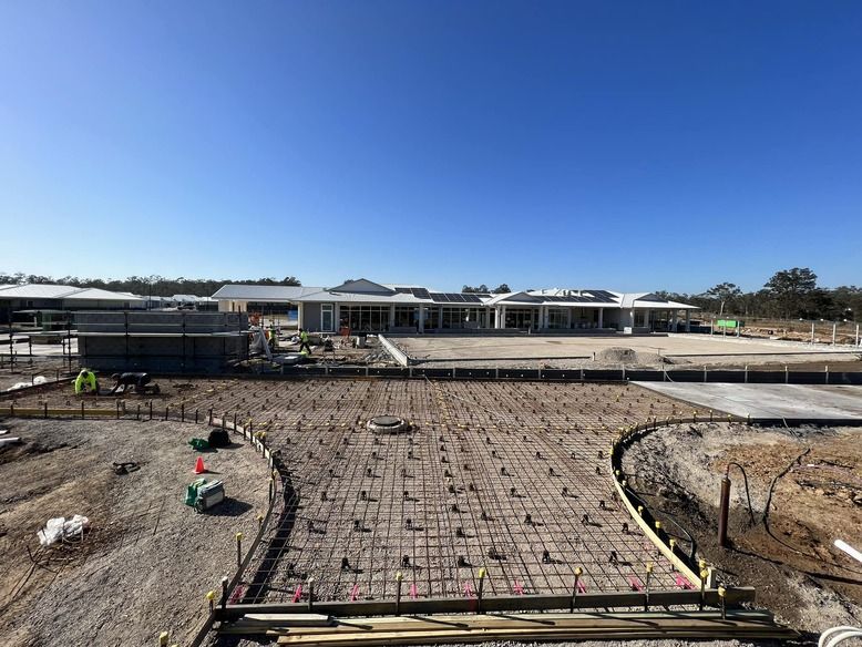 A Large Building is Being Built in the Middle of a Dirt Field — Coastal Kerb and Concrete In Buff Point, NSW