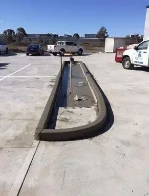 A Concrete Curb is Being Built in a Parking Lot — Coastal Kerb and Concrete In Buff Point, NSW