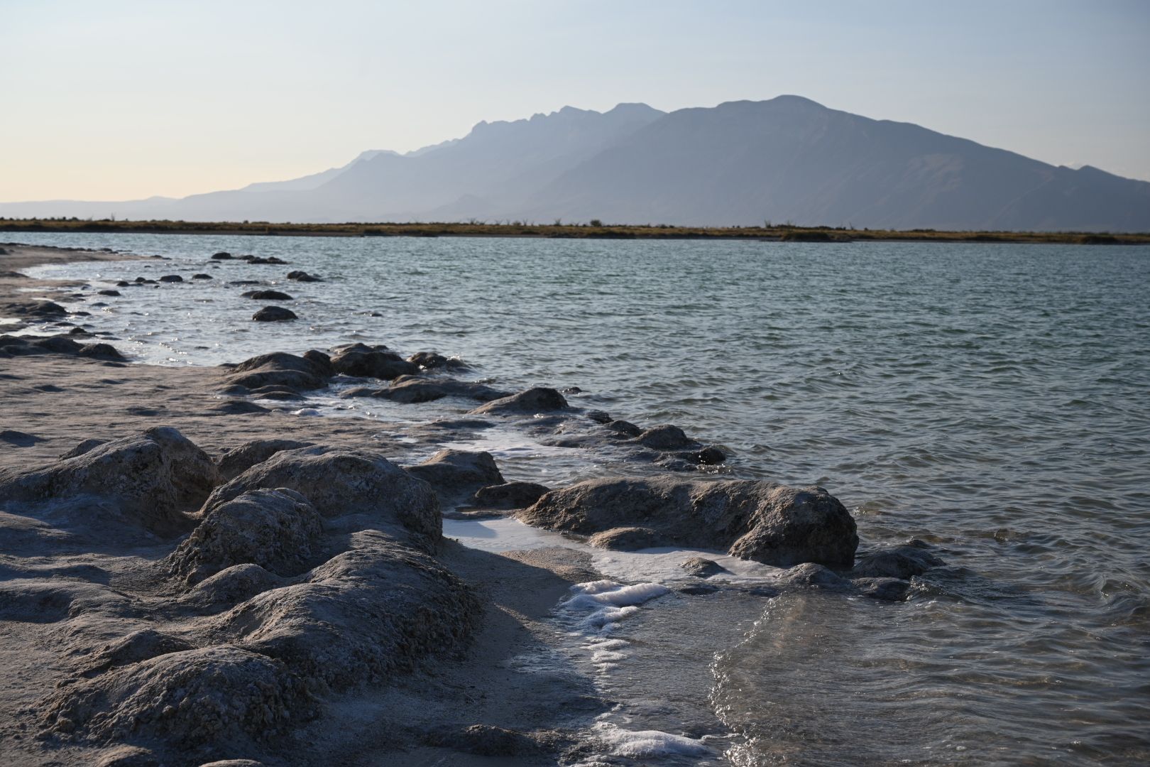 A large body of water with mountains in the background