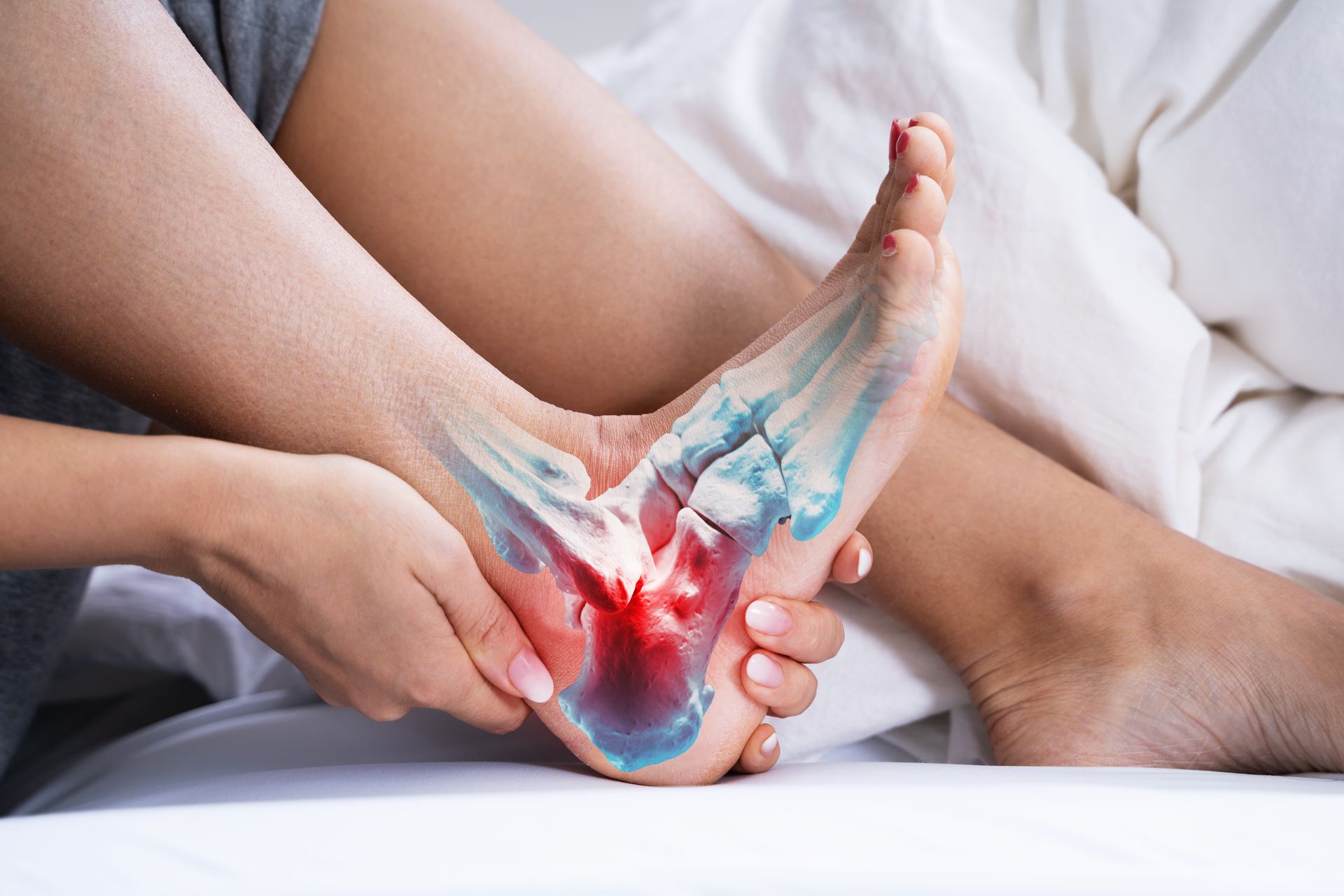 Person holding foot, showing pain and highlighting bone structure with red and blue overlay.