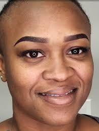 Woman with freshly styled, defined permanent eyebrows.