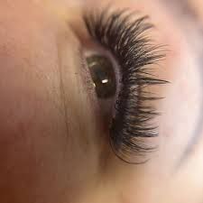 Close-up of eye with long, voluminous eyelash extensions.