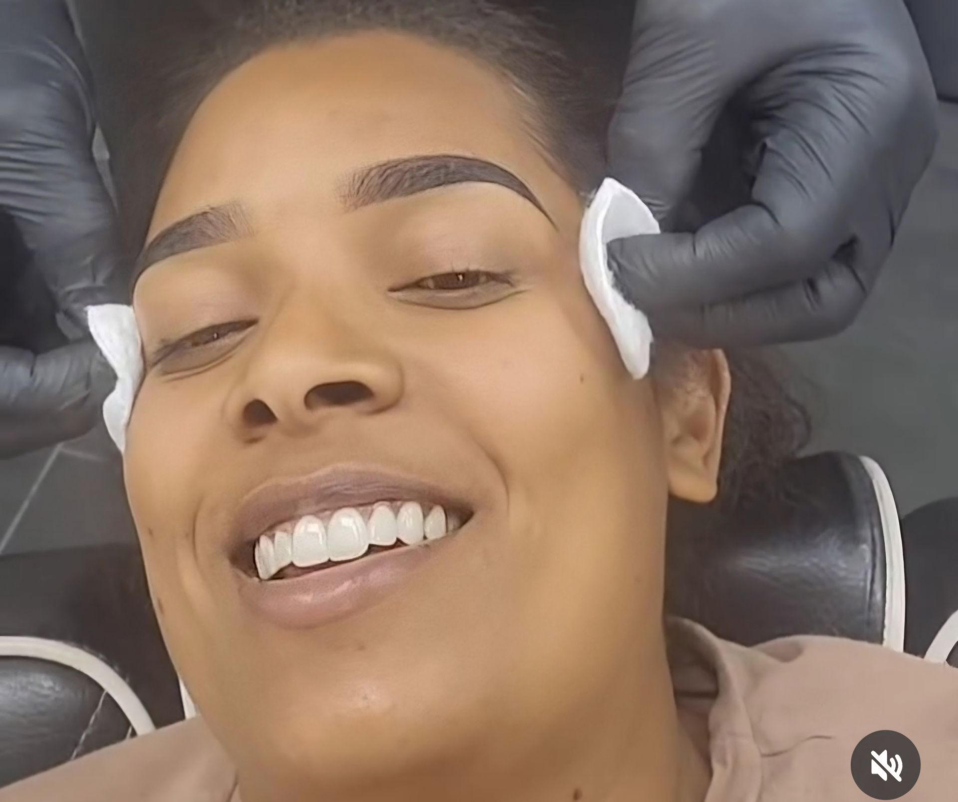 A close up of a woman 's face with her hand on her chin.