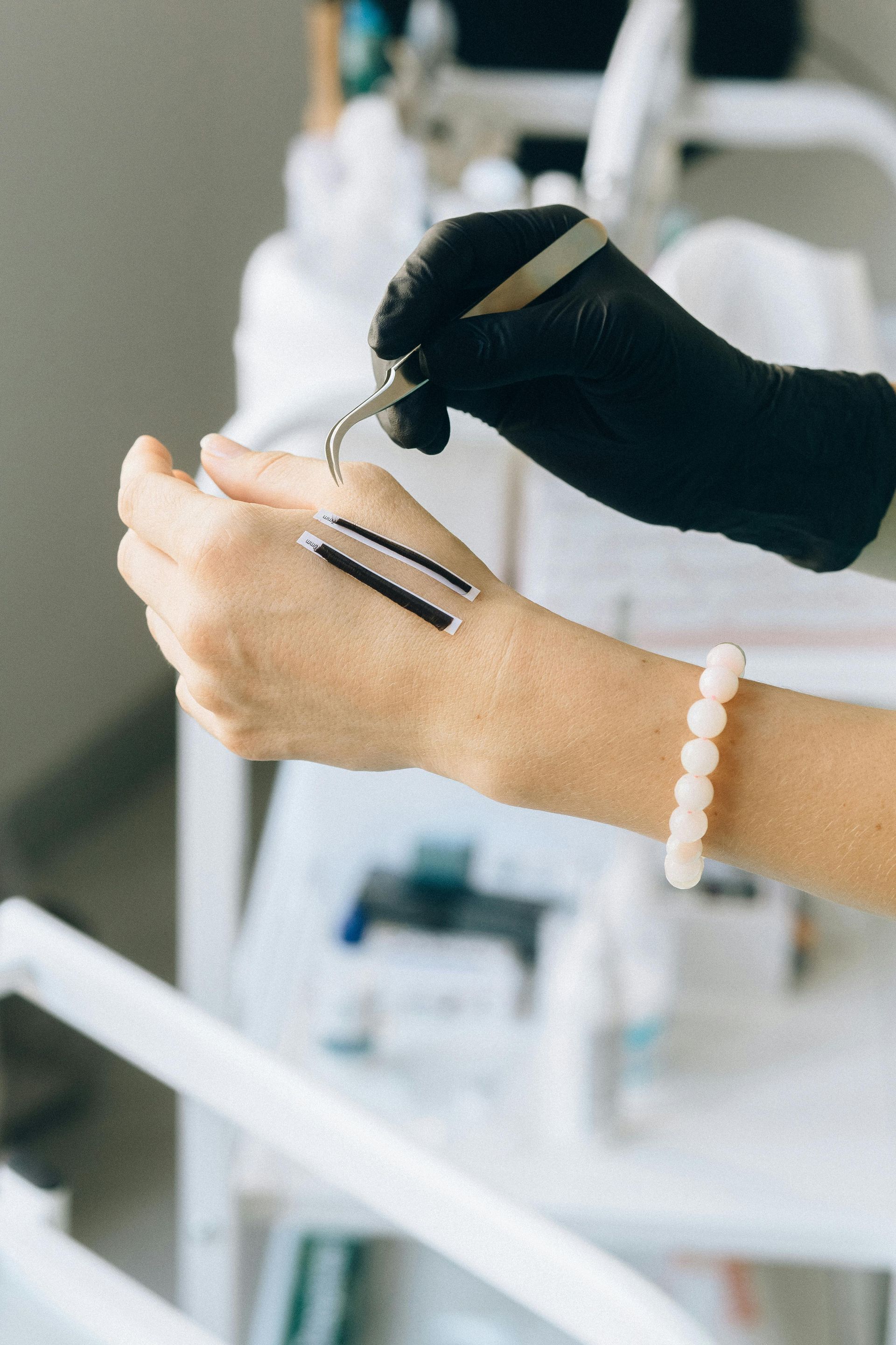 A woman is applying a serum to her hand.