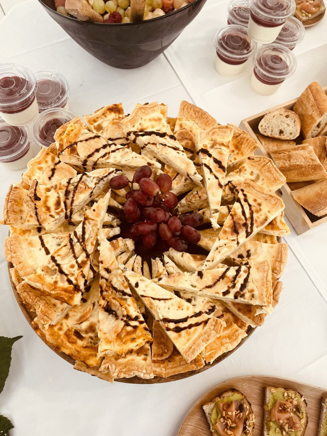 Apéritif composé d'un pain plat en couches garni de glaçage balsamique et de raisins.