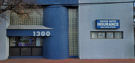 A blue and white building with a sign that says quick auto insurance