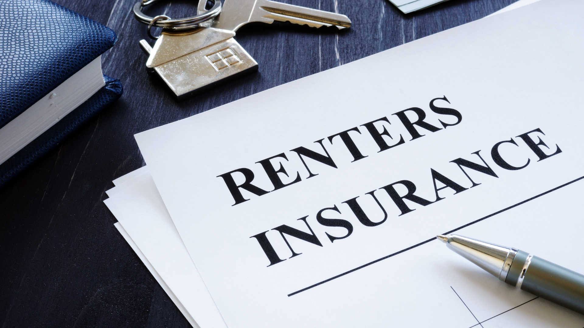 A pen is sitting on top of a piece of paper that says renters insurance.