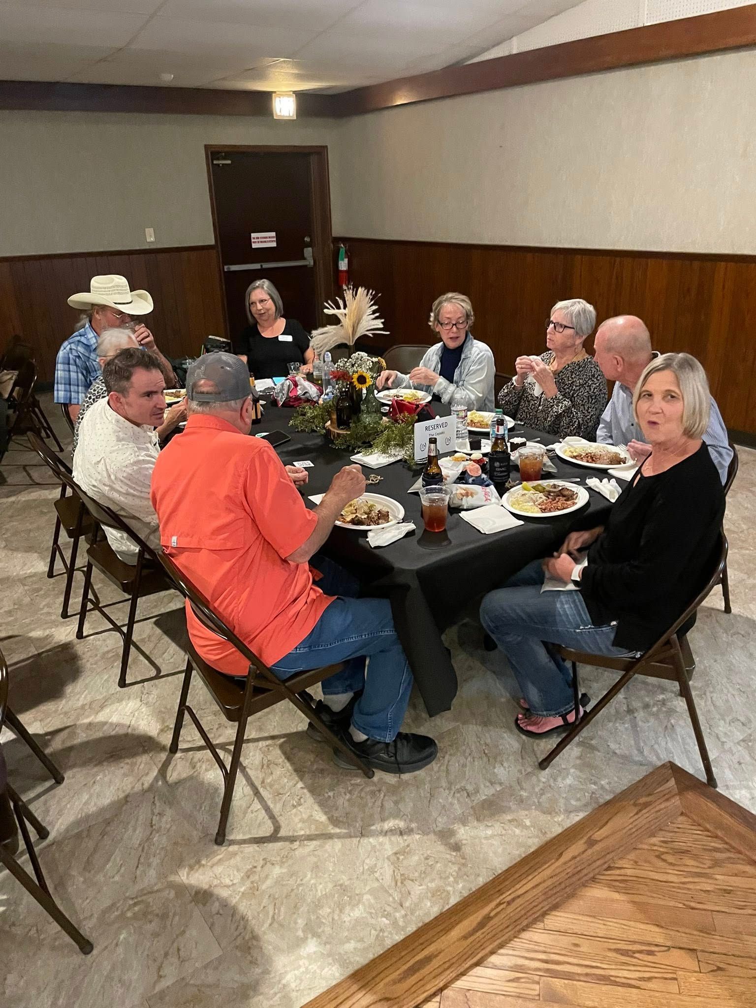 Horse in pen with an American flag; horse is brown and white.