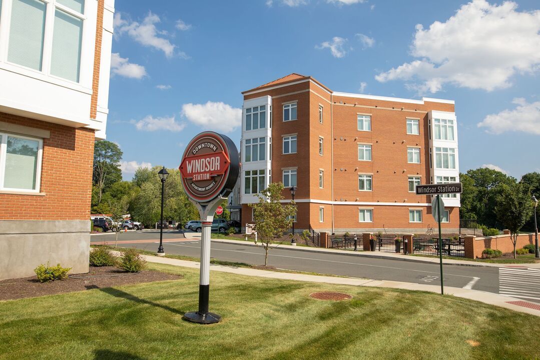 A stop sign is in front of a brick building.