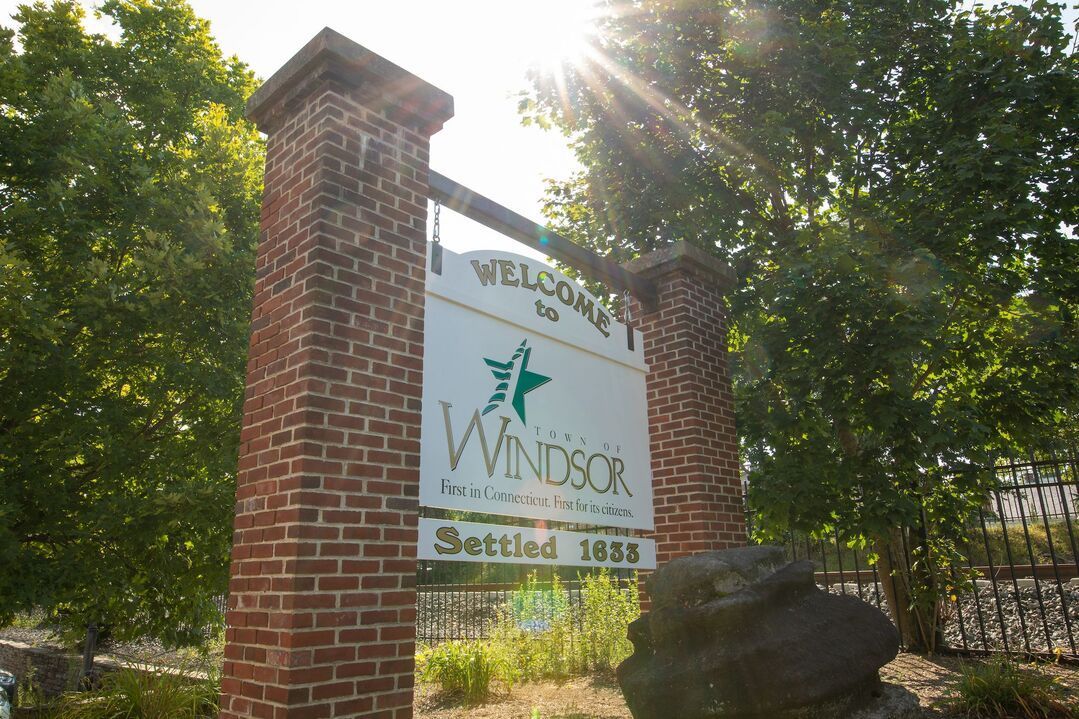 A brick post with a sign on it that says winddock