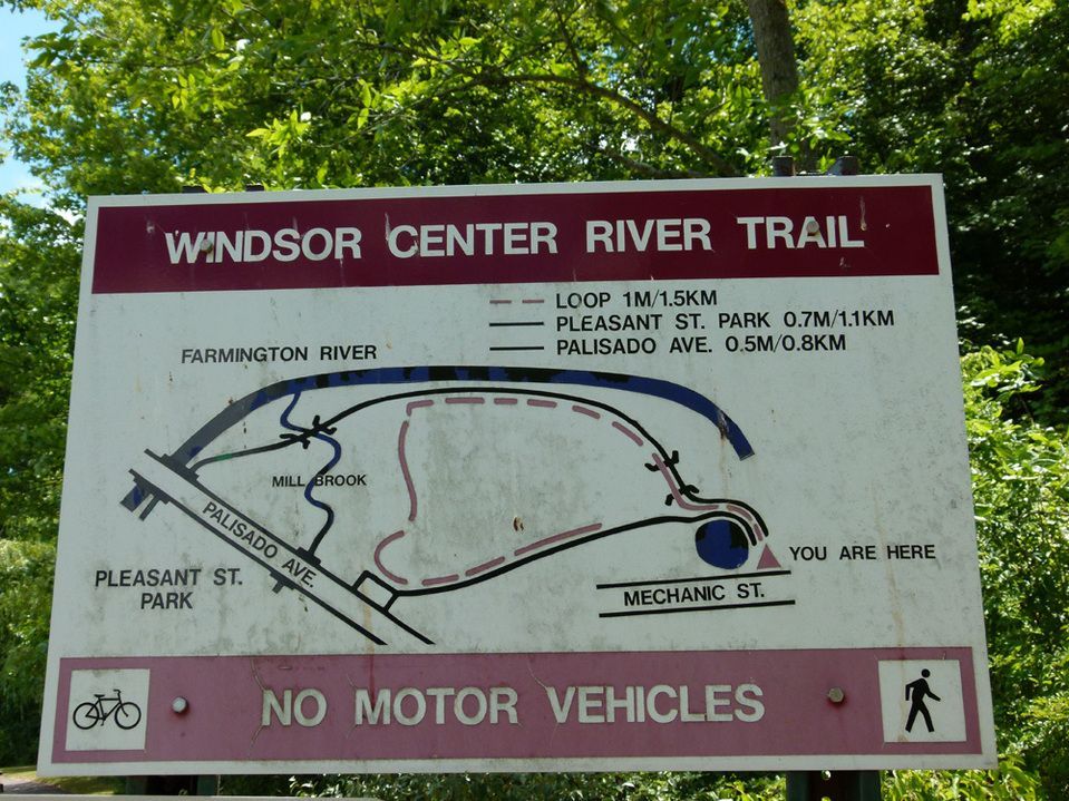 A sign for windsor center river trail says no motor vehicles