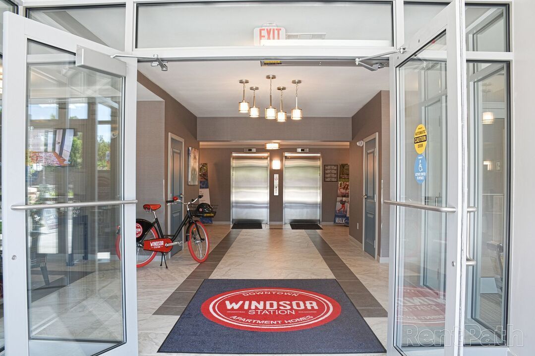 A bicycle is parked in the hallway of a building.
