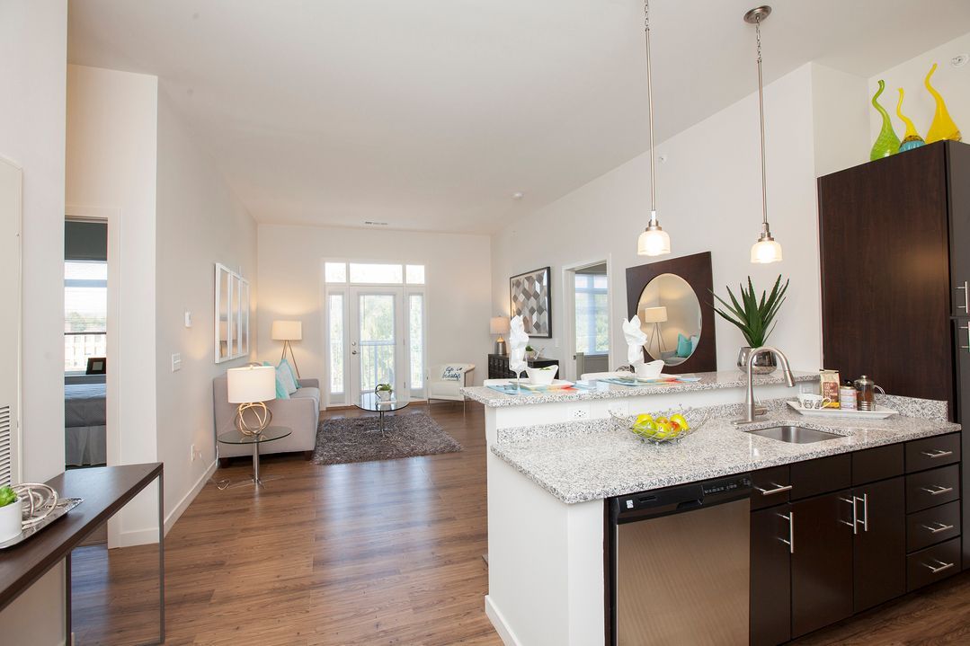 A kitchen with granite counter tops and stainless steel appliances
