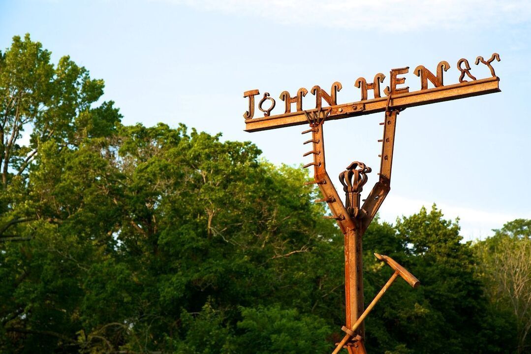 A wooden sign that says john henry on it