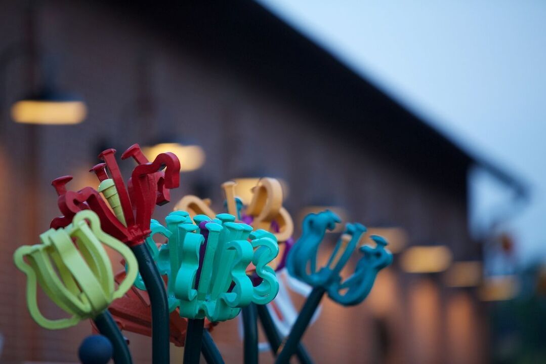 A bunch of colorful scissors in front of a building