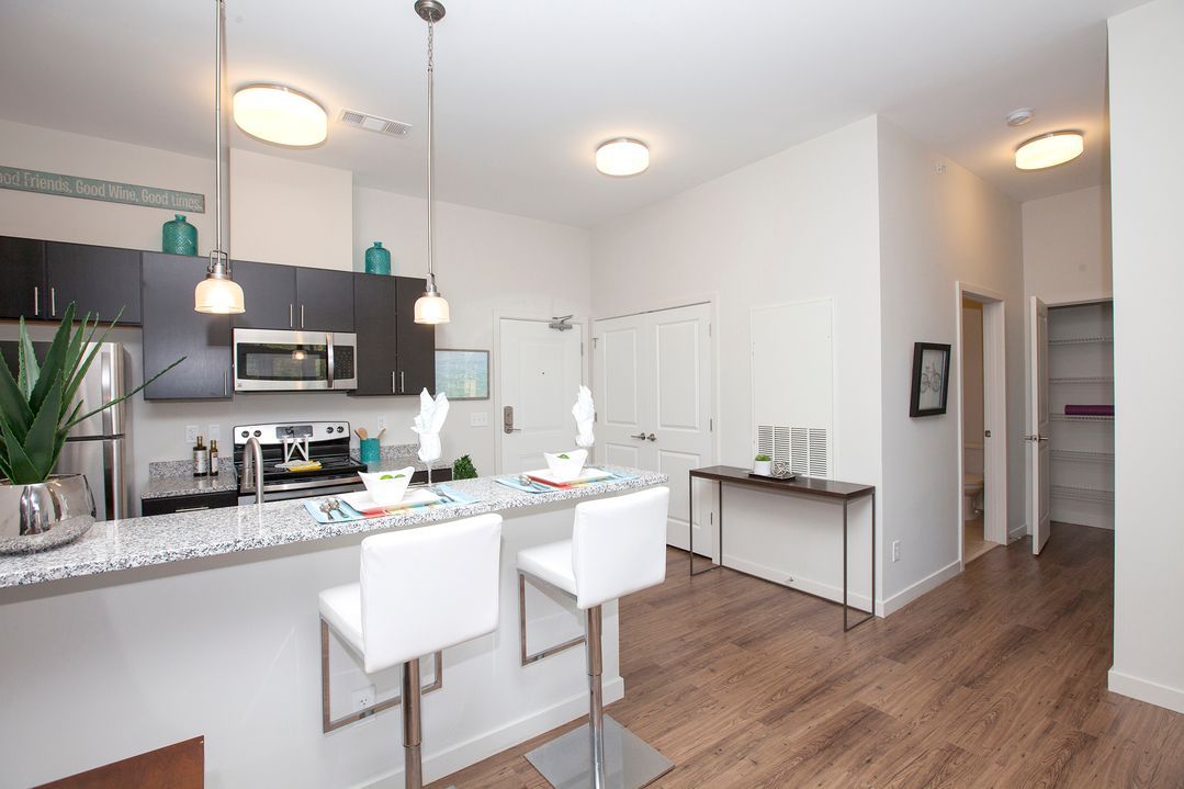 A kitchen with a bar and stools in it