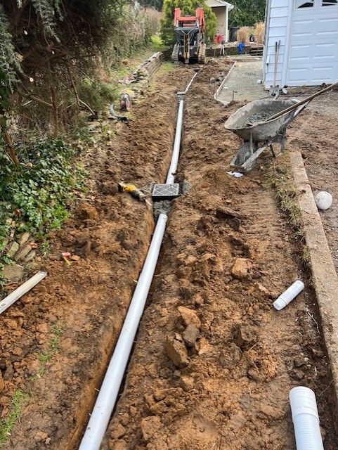 Drain pipes installed in ground to address water pooling near house