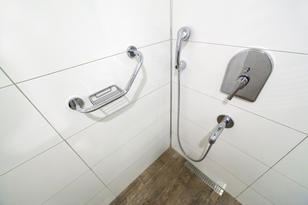 A bathroom with a walk in shower and a soap dish.