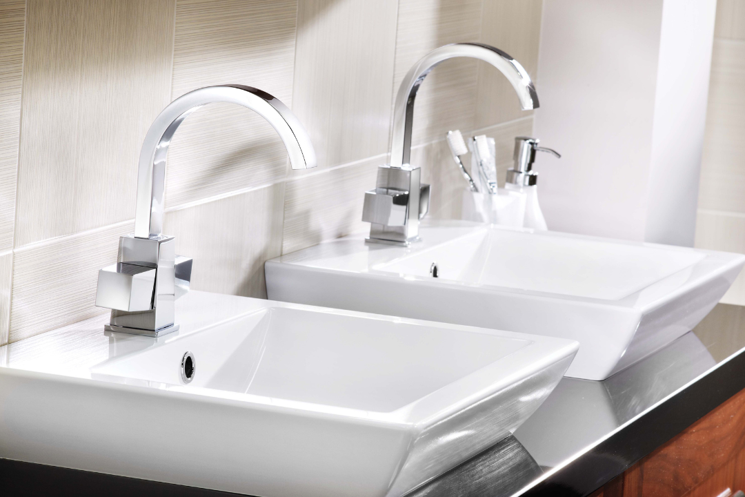 Two white sinks with chrome faucets in a bathroom