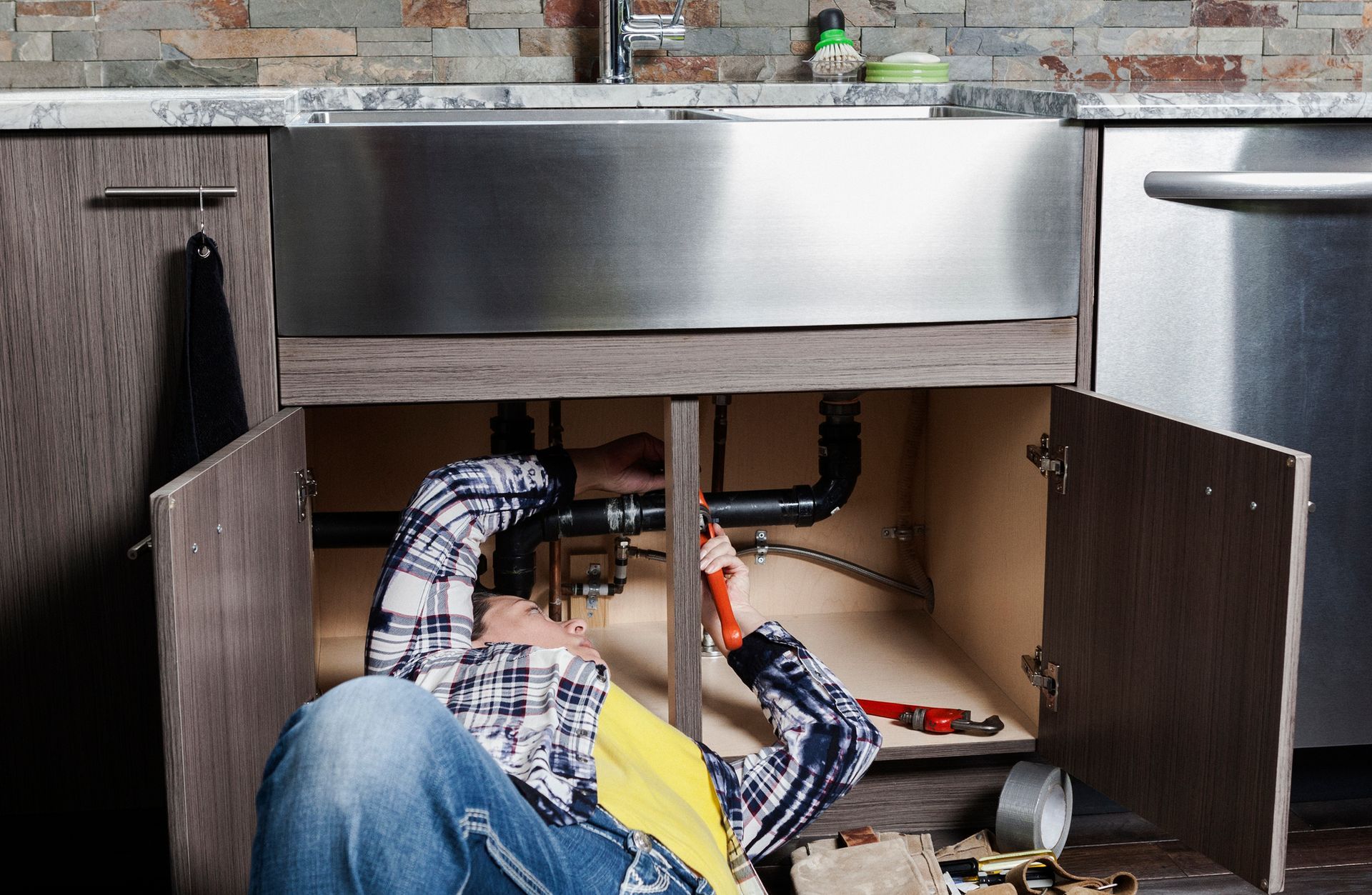 Man Repairing The Tank's Pipe — Plumbing Repairs in Saint Ann, MO