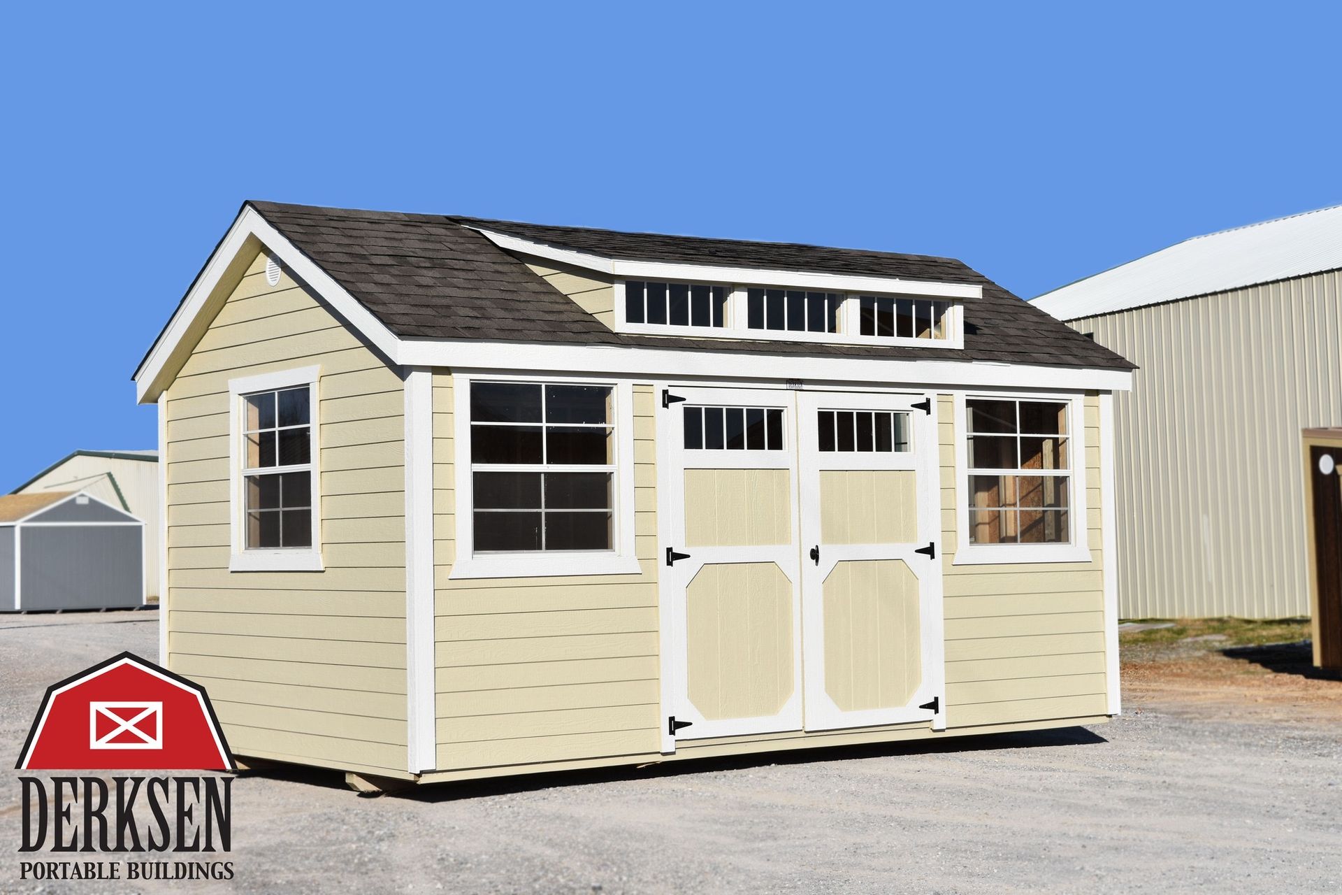 A small shed with a roof that looks like a barn