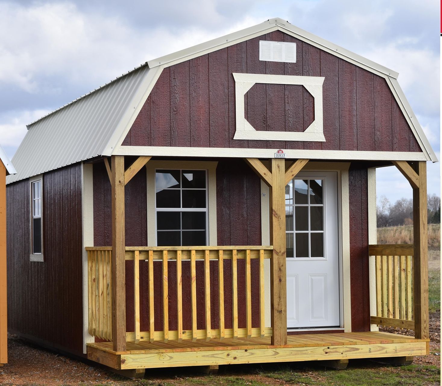 A red shed with a birdhouse on the side of it